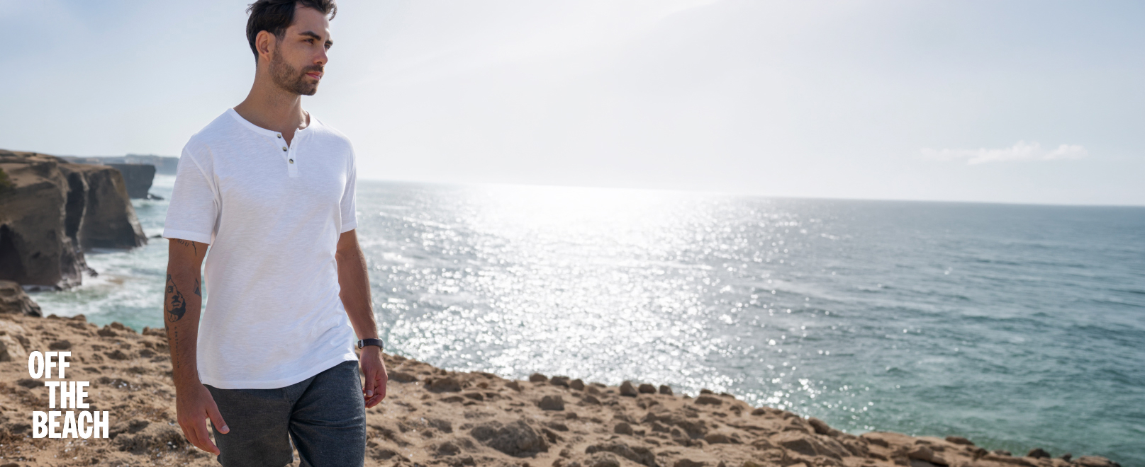 Men on the beach wearing a white T‑shirt and a linen shirt‑and‑pants set from Off The Beach. 